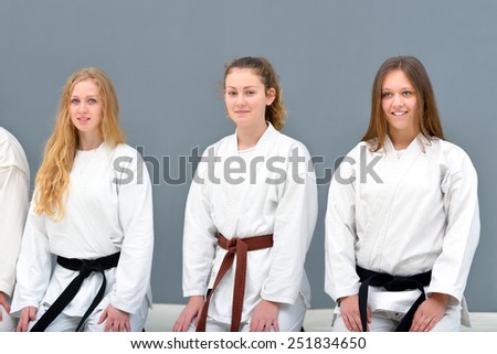 young, beautiful and successful karate fighters in combat positions