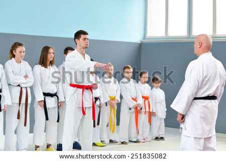Karate master shows a group of young martial arts