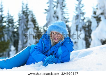 young and beautiful blond is having fun in the snow