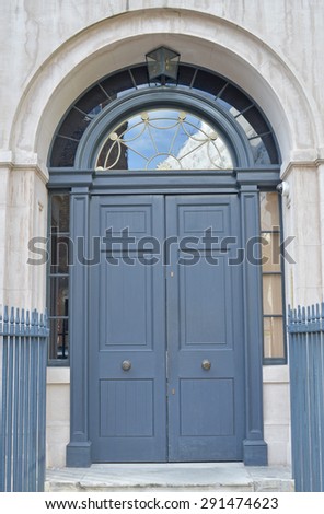 Large grey door with half circle window