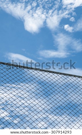 steel net fence against blue sky
