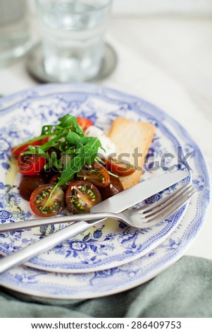 tomato salad on a fancy dinner set