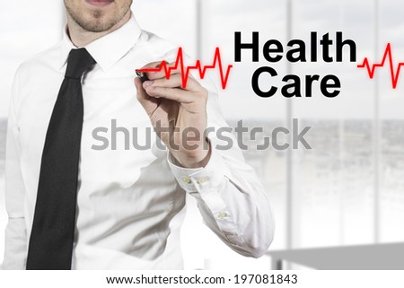 doctor in hospital drawing heartbeat line with healt care in the air