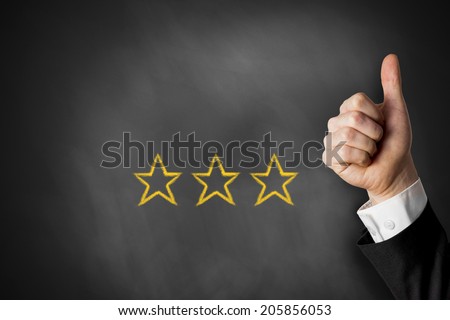 thumbs up with three golden rating stars on black chalkboard