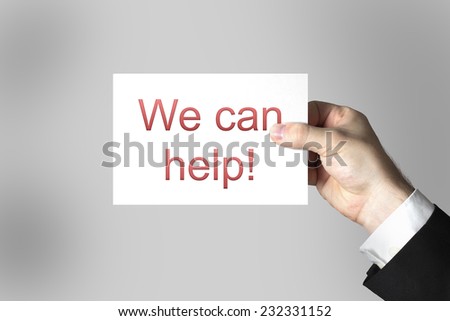 business mans hand holding card sign we can help