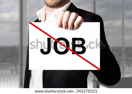 businessman in black suit holding sign job crossed out jobless