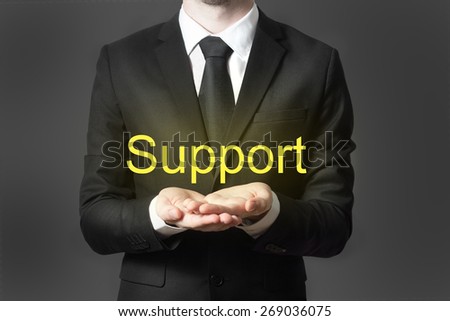 businessman in office offering support hands open
