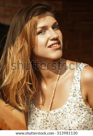 Beautiful natural young smiling fashion summer caramel blonde girl woman portrait outdoor in a natural dress with a fresh caramel face and lips