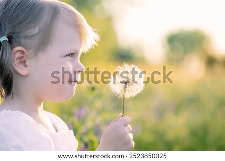 Similar – Image, Stock Photo Child holding dandelion