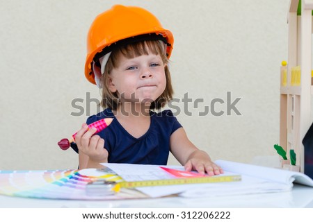 Kid in construction helmet pretending to be an architect - Construction, Architecture,  Home Improvement and Childhood concept - cute little girl in protective helmet - playing engineer /builder