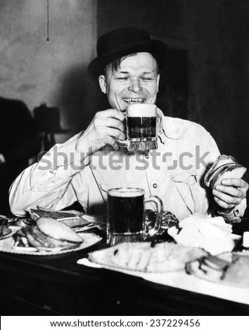 Chicago worker enjoys a saloon lunch that provided free food to go with the purchased beer Ca 1920.