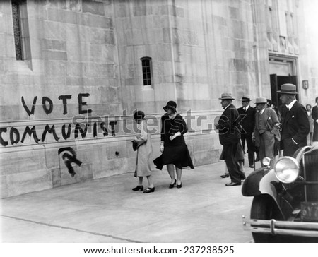 VOTE COMMUNIST\' is painted on the Church of Heavenly Rest on Fifth Ave and 90th Street Wealthy parishioners observe the sign as they leave the church after the morning service.