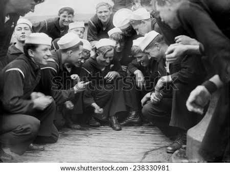 Sailors playing a dice game on the New York, original title: \'Shooting craps on New York\', photograph circa 1900s-1930s