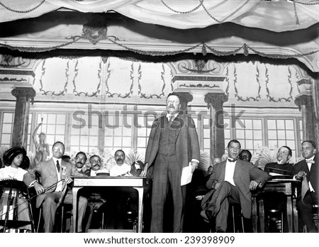 Theodore Roosevelt speaking at National Negro Business League in 1910. Seated to his left is Booker T. Washington, noted African American leader.