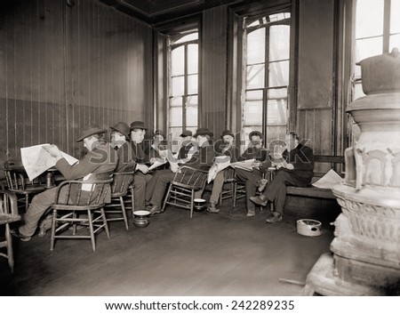 Homeless men in the reading room of a dime a night Bowery lodging house in 1910.