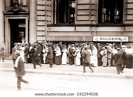 A long line of men and women line up in a run on the German American Bank of New York City. Ca. 1905-1915.