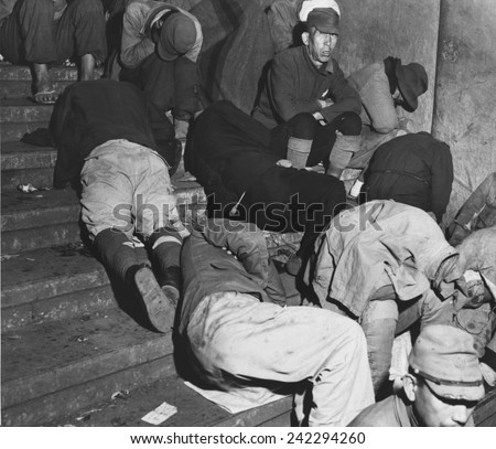 Homeless Japanese in Tokyo, months after Japan\'s World War II surrender, spend the night on the steps of one of Tokyo\'s subway stations. Dec. 6, 1945.