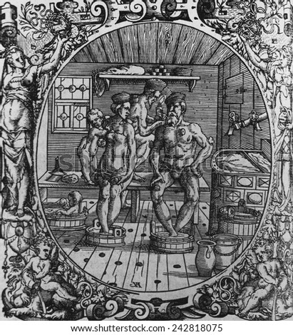 16th century scene of therapeutic bathing and cupping. A man and a woman in a sauna, soaking their feet in water, with a child and physician. 1565 woodcut from Paracelsus\'s, OPUS CHYRURGICUM.