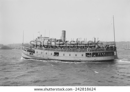 Immigrant ferry boat in New York Harbor. Ferries were used to transfer immigrants from their ocean crossing ships to Ellis Island Immigration Station, from Ellis Island to the mainland. Ca. 1910.