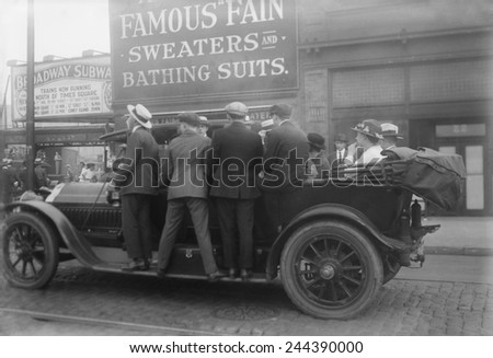 Men ride on the running boards of a improvised mass transit vehicle during a strike in Brooklyn, ca. 1915.