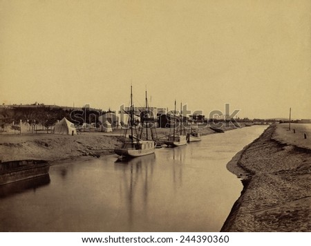 Small boats moored at water\'s edge to the Suez Canal at Ismailia. The Ismailia segment of the modern canal was completed in November 1862. 1860 photo by Francis Frith.