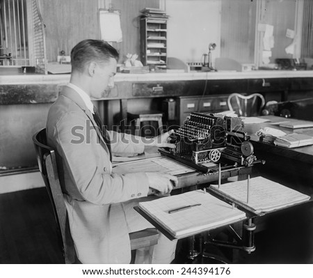 Man operating a Post Office money order machine. Ca. 1930.