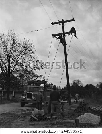 Developing TVA (Tennessee Valley Authority) electric transmission lines as part of Franklin Roosevelt\'s \'New Deal\' rural electrification.
