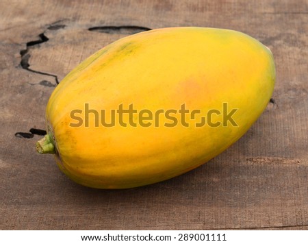 fresh yellow papaya isolated on white on wooden board