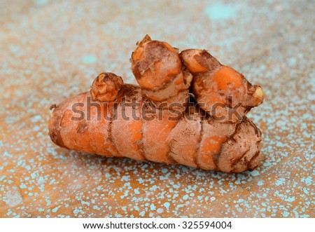Fresh turmeric root, and ground spice - shallow depth of field