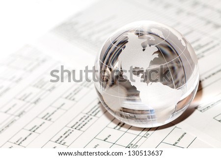 Glass globe with North America and business papers