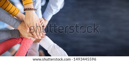 Close up top view of young business people putting their hands together. Stack of hands. Unity and teamwork concept. Foto d'archivio © 