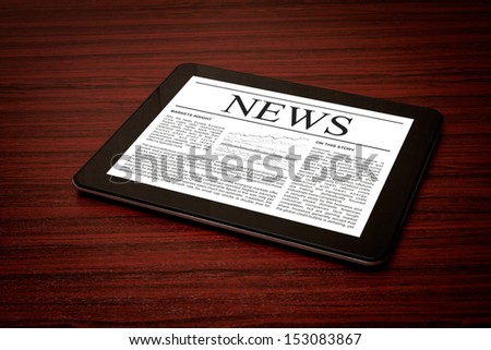 Tablet PC shows latest news on screen, which lying on work place.