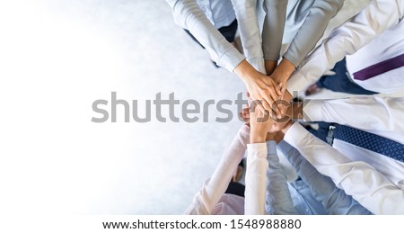 Close up top view of young business people putting their hands together. Stack of hands. Unity and teamwork concept. Stock foto © 