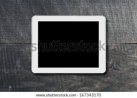 tablet touch computer gadget with isolated screen on a background of wood
