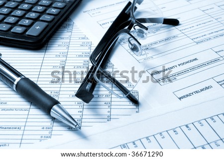 A calculator, pen, and financial statement.