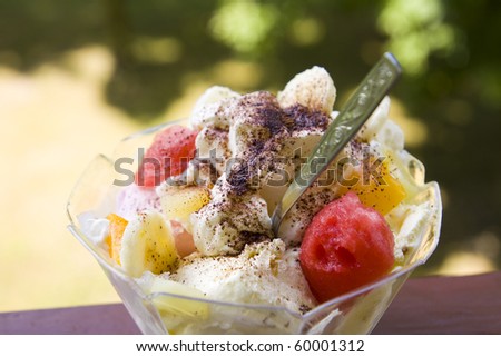 Ice cream dessert in glass cup on green background
