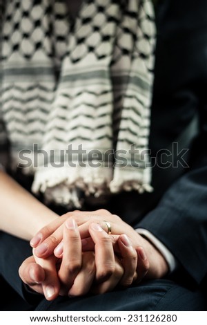 Husband holding wife\'s hand