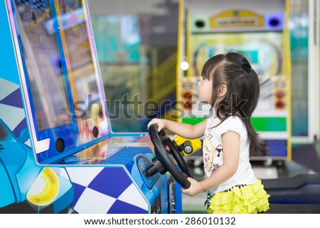little asian girl play video game