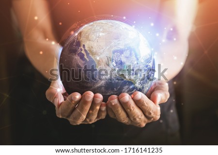 Businessman holding in hands with global connection concept. Energy saving concept, Elements of this image furnished by NASA