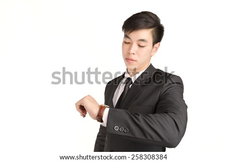 Young Businessman checking the time on his wrist watch : hurry time