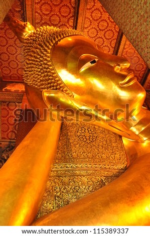 BANGKOK, THAILAND - AUGUST 12: Details of the Reclining Buddha statue at the Wat Pho temple in Bangkok, Thailand on August 12, 2012. The statue is 15m high and 43m long.