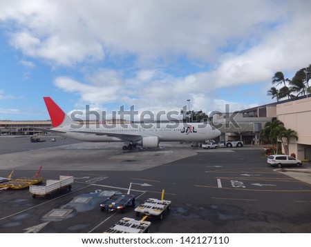 HONOLULU, HI - JANUARY 5: JAL airlines plane sits at Honolulu International (HNL) airport waiting to load up passengers, on January 5, 2013. HNL is one of the busiest airports in the US.