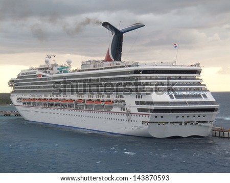 COZUMEL, MEXICO - NOVEMBER 23: The Carnival Conquest sails away from Cozumel in Mexico on November 23, 2012. The Godmother of Carnival Conquest is Lindy Boggs, former US Congresswoman for Louisiana.