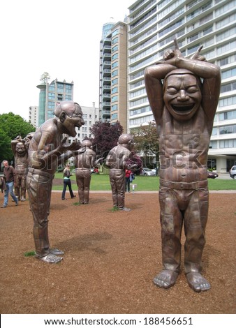 VANCOUVER, CANADA - MAY 22: A-Maze-ing Laughter sculptures located by English Bay at Morton Park in Vancouver, Canada, on May 22, 2010. These 14 bronze oversized men were created by artist Yue Minjun.