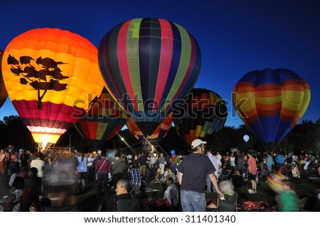 PLAINVILLE, CT - AUG 28: Balloon Glow at Dusk at the 2015 Plainville Fire Company Hot Air Balloon Festival held from August 28-30, 2015. Thousands of people attended this festival in its 31st year.