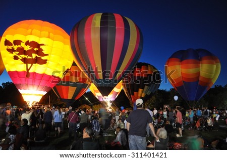PLAINVILLE, CT - AUG 28: Balloon Glow at Dusk at the 2015 Plainville Fire Company Hot Air Balloon Festival held from August 28-30, 2015. Thousands of people attended this festival in its 31st year.