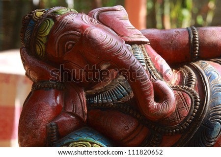 Ganecha in relaxing. Wooden Sculpture of Lord Ganesha, Hindu god of success. Photo taken in India, the State of Goa, Vagator.