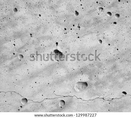 Concrete wall with cracking like moon surface.