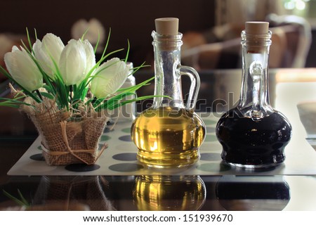 Oil and Vinegar. Bottles of olive oil and vinegar on a table in a cafe.