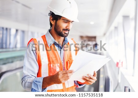 Similar – Image, Stock Photo Mechanic reading document in workshop